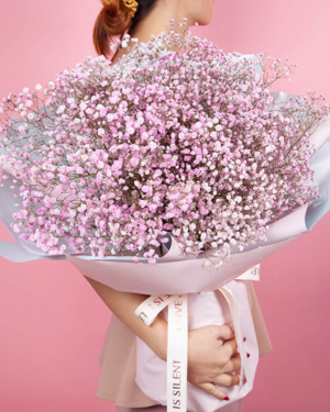 Medium bouquet of pink-dyed baby's breath flowers wrapped in quality matte paper
