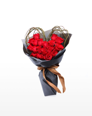 Medium bouquet of 19 red roses that features a heart-shaped wreath wrapped in matte paper