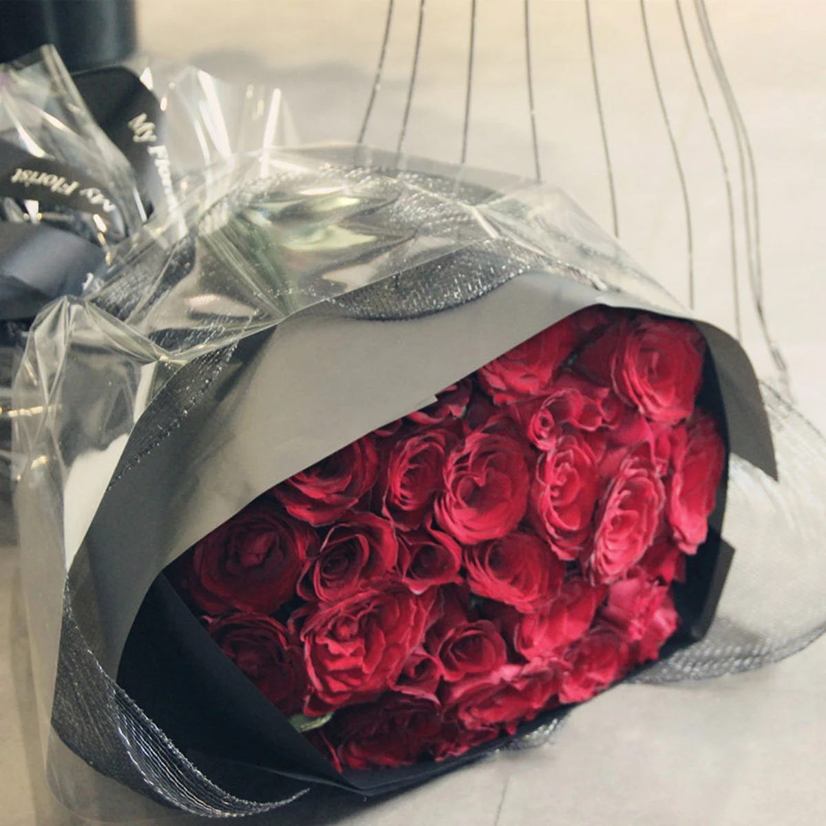 Medium bouquet of 33 premium red roses wrapped in quality matte paper