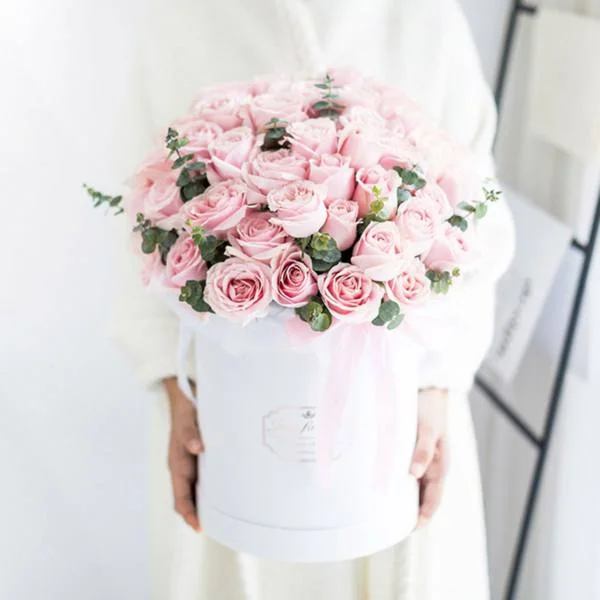 Large bouquet of 52 premium pink roses arranged in a cylinder gift box