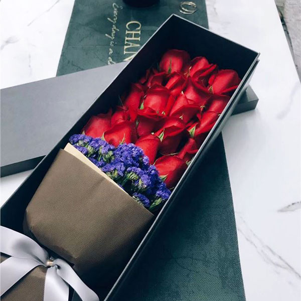 Medium bouquet of 19 red roses and purple 'forget-me-not' flowers presented in an elegant gift box