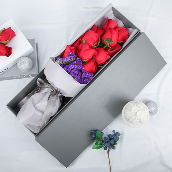 Medium bouquet of 11 red roses and purple 'forget-me-not' flowers wrapped in quality matte paper & arranged in an elegant gift box