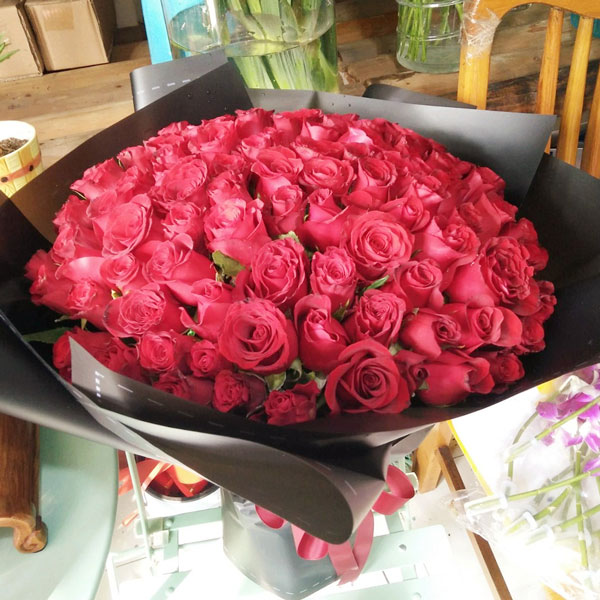 Large bouquet of 99 premium red roses wrapped in quality matte paper