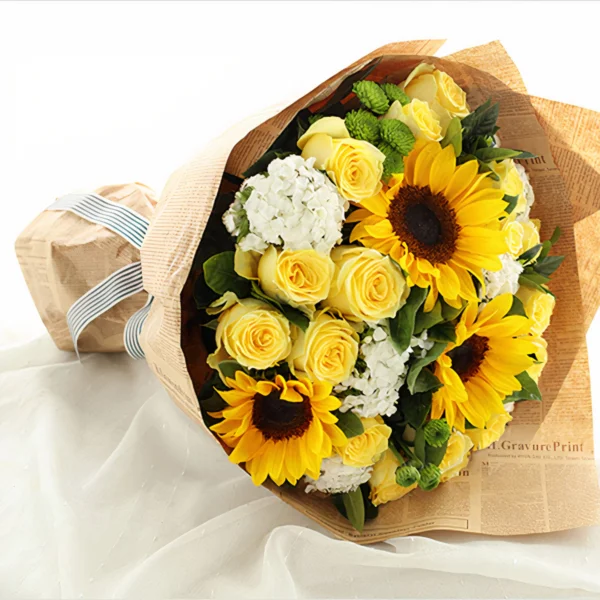 Medium bouquet of sunflowers, roses, daisies, dianthus and gardenia leaves wrapped in brown kraft paper